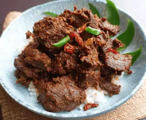Creamy and flavorful Beef Rendang with tender beef chunks simmered in rich coconut milk and aromatic spices, served with rice.