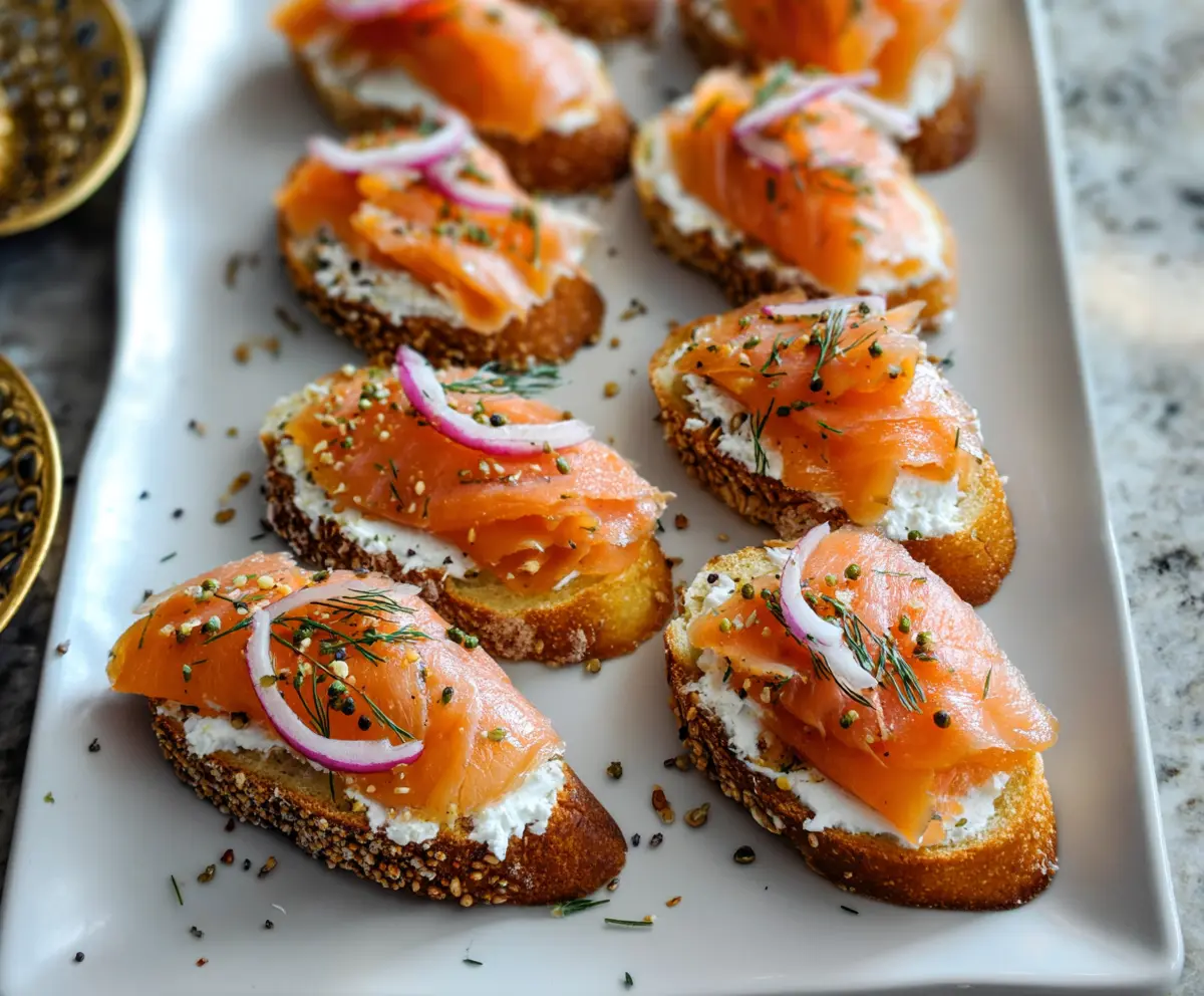 Delicious smoked salmon crostini garnished with fresh herbs on a rustic serving platter.