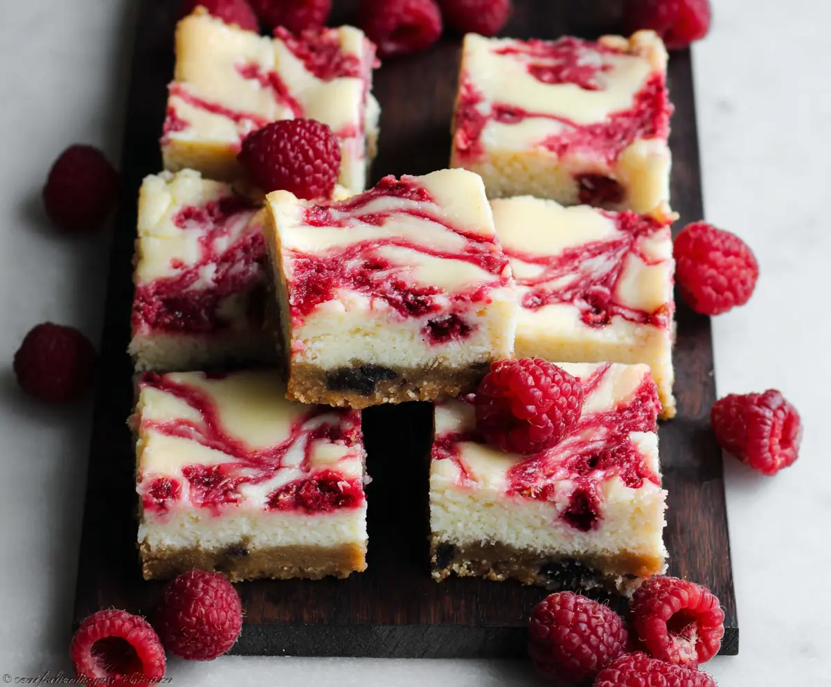 Delicious white chocolate raspberry cheesecake bars with a creamy texture and fresh berry topping