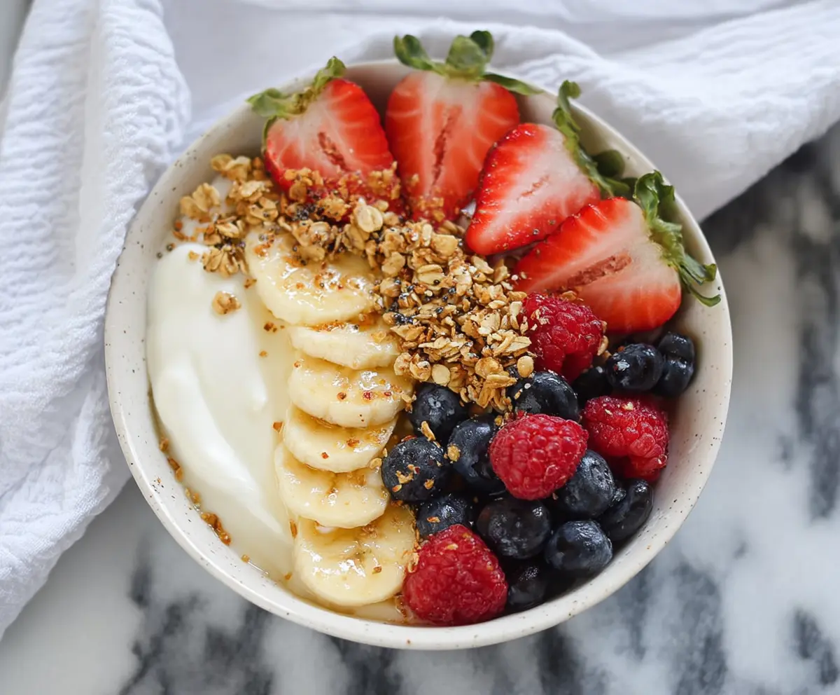 Healthy Greek Yogurt Protein Bowl with fresh berries, nuts, and honey for a nutritious breakfast.