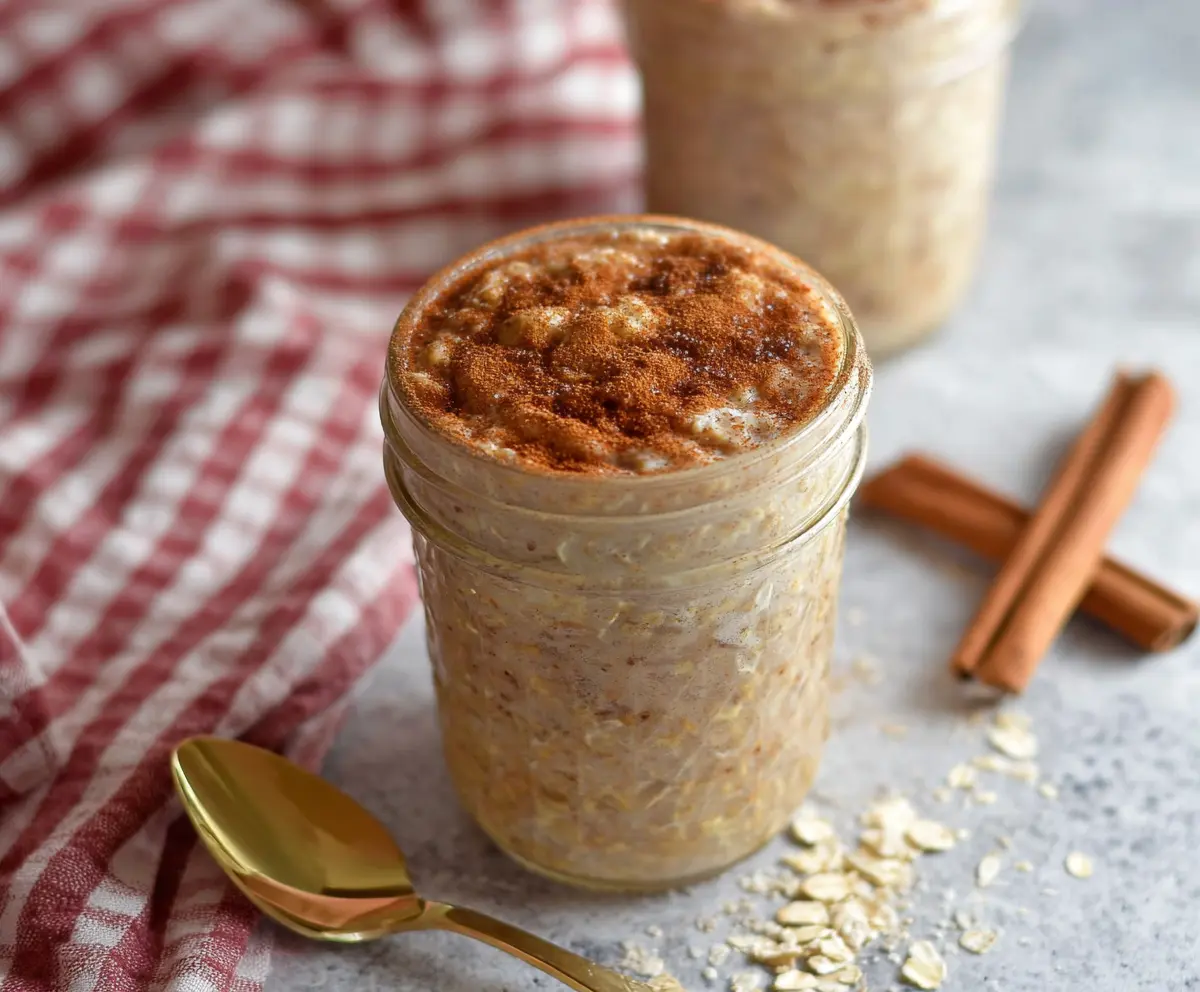 Delicious Snickerdoodle Overnight Oats topped with cinnamon sugar and cream cheese for a sweet breakfast.