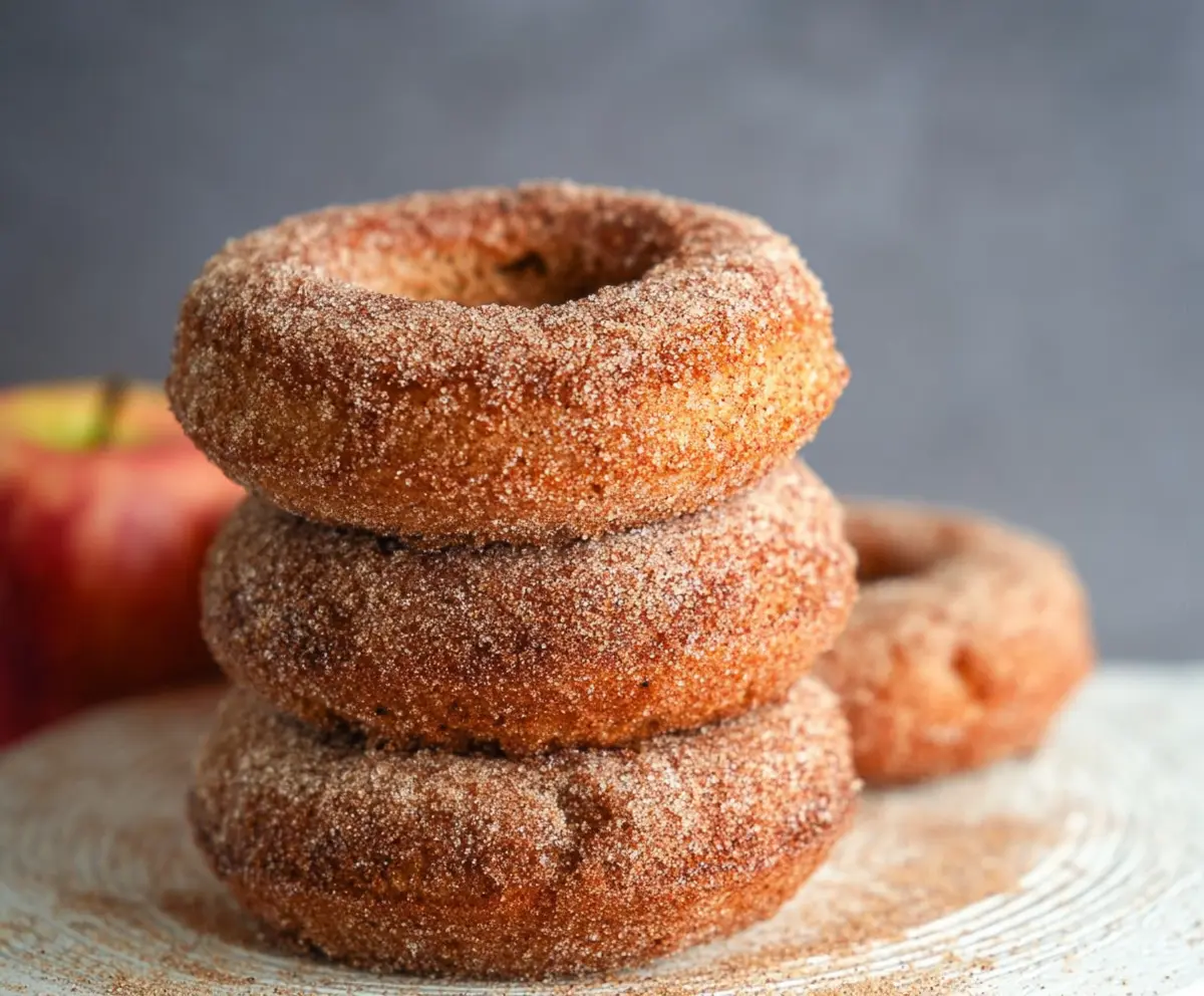 Homemade sourdough discard apple cider donuts bread on a rustic wooden table.