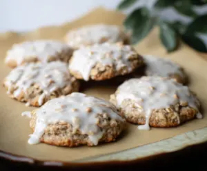 Delicious sourdough discard glazed oatmeal cookies on a rustic wooden table.