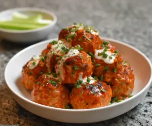 Savory Buffalo Chicken Meatballs served with a spicy buffalo sauce.