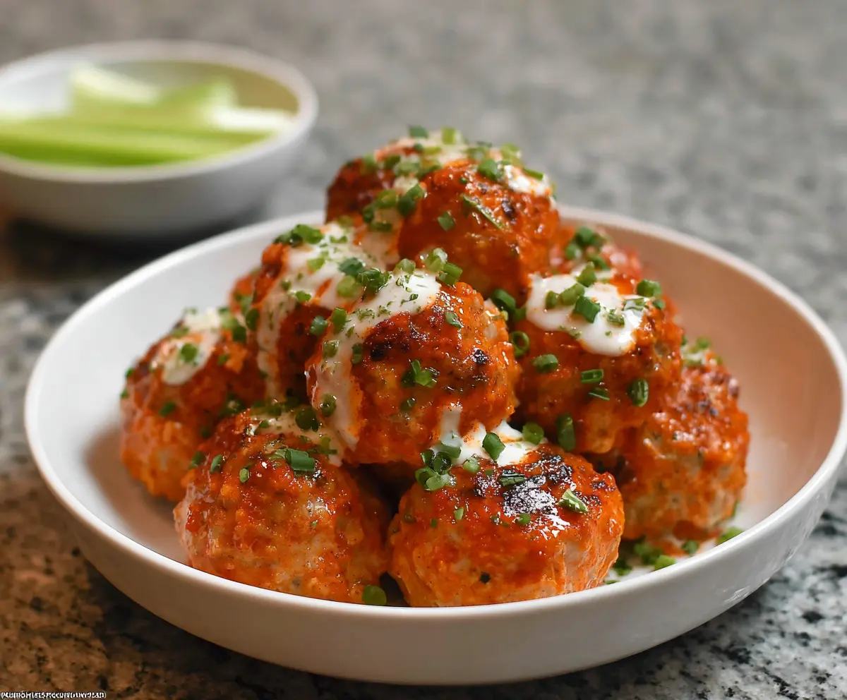Savory Buffalo Chicken Meatballs served with a spicy buffalo sauce.
