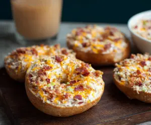 Delicious creamy bacon cheddar bagels with crispy bacon and melted cheese.
