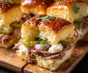 Delicious Cuban Sliders with ham, Swiss cheese, and pickles on a toasted bun