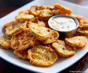 Crispy fried pickles with golden-brown coating served as a delicious appetizer