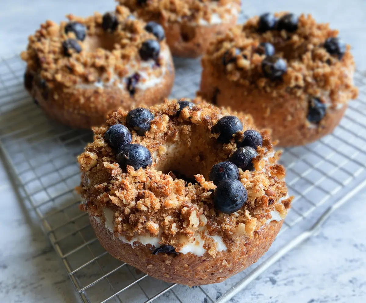 Healthy Greek yogurt blueberry crunch bagels with fresh blueberries and crunchy toppings.
