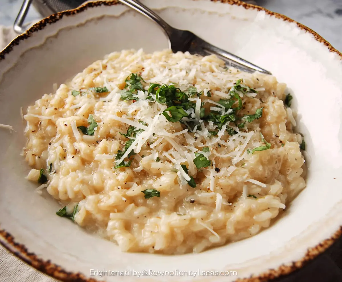 Creamy Parmesan Risotto served in a bowl, garnished with fresh herbs for a delicious Italian dinner.
