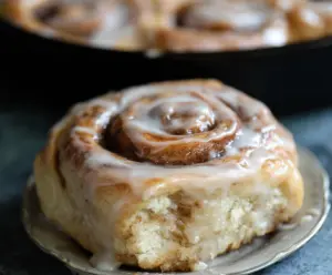 Delicious sourdough apple cider cinnamon rolls glazed and freshly baked.