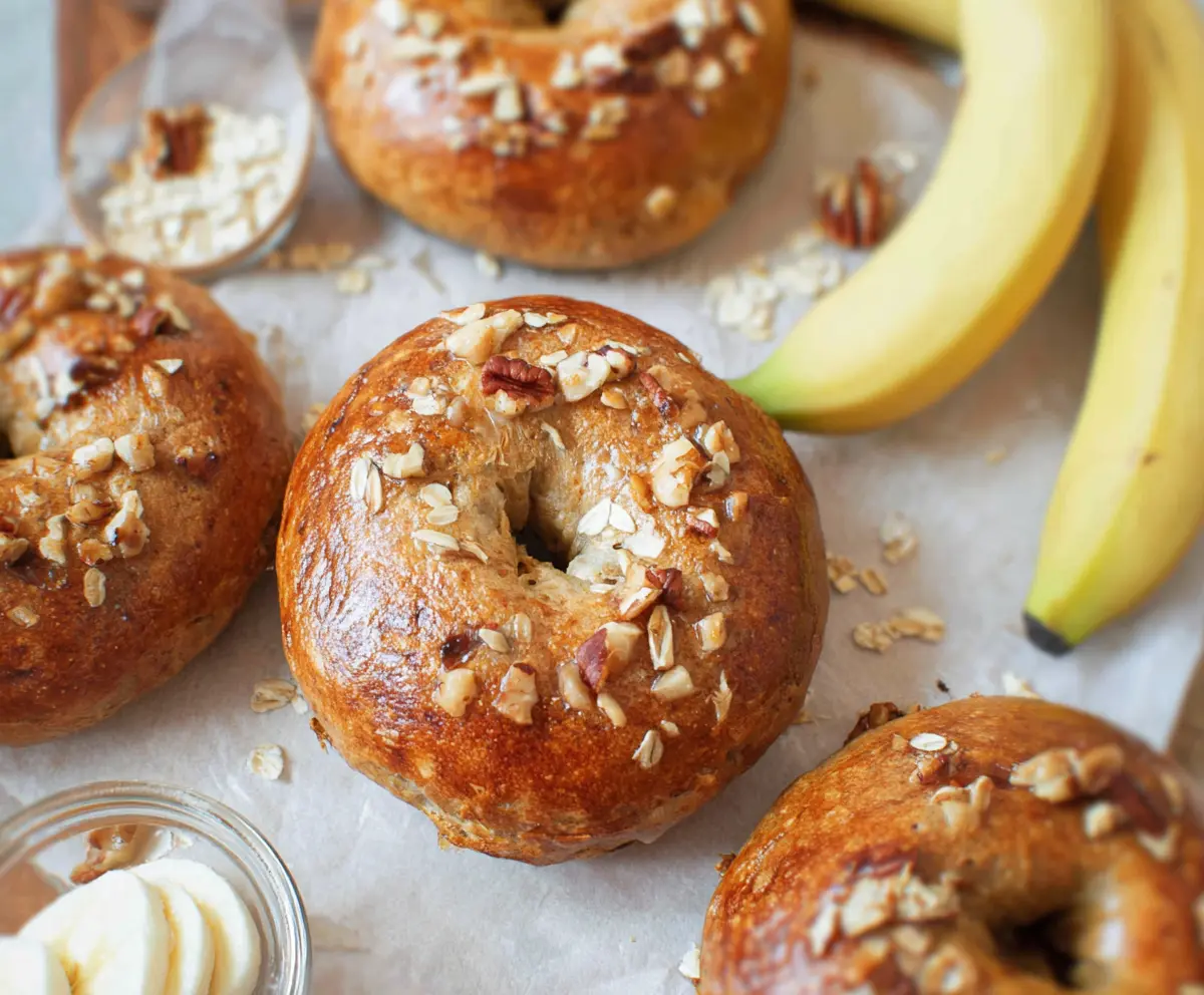 Delicious homemade banana nut bagels with ripe bananas and crunchy walnuts on a baking tray.
