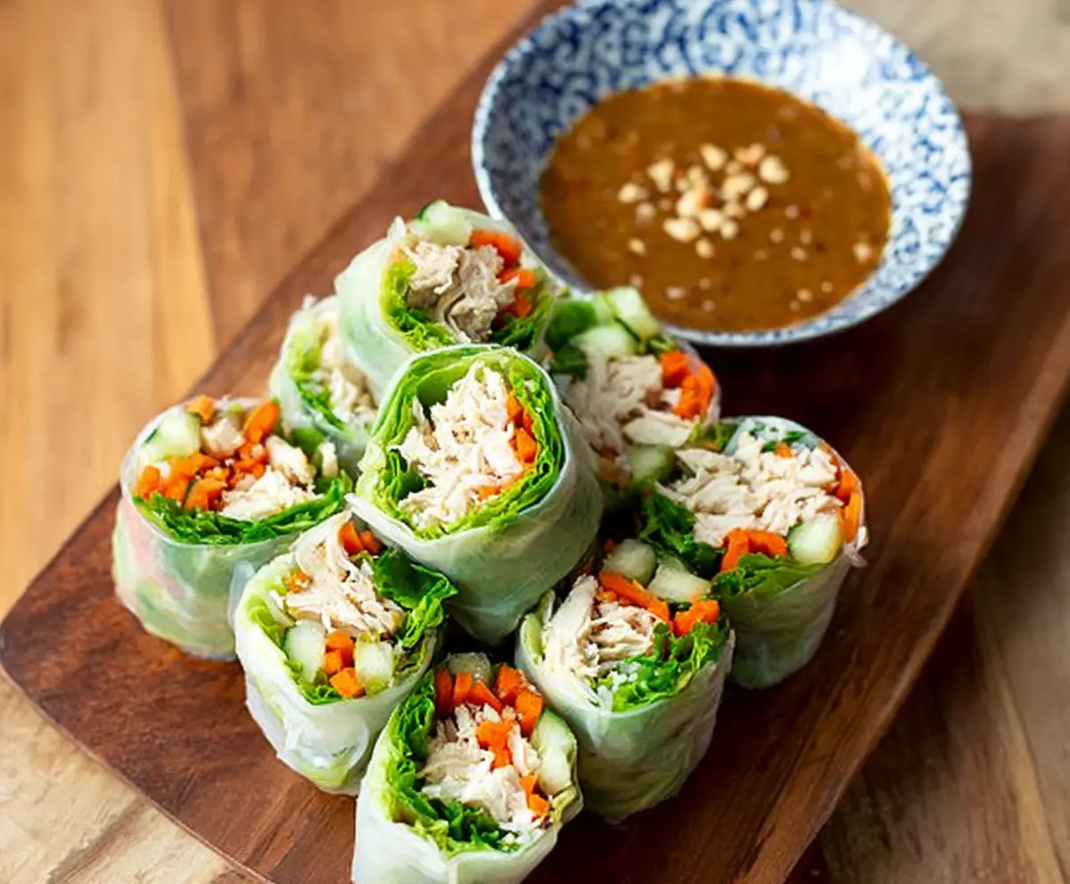 Delicious Bang Bang Chicken Rice Paper Rolls with fresh vegetables and spicy sauce.