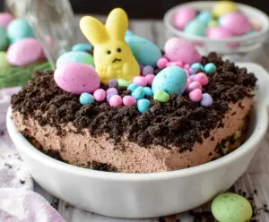 Delicious Easter Dirt Cake with chocolate pudding, crushed cookies, and colorful sprinkles served in a festive dish
